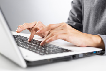 Student sitting at desk and working at laptop