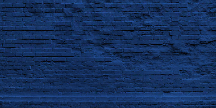Panoramic Wall of Classic Blue Bricks in Color 2020 - 19-4052. Navy Wide Banner for Web With Textured Blue Surface. Luxury Facade or Face Wall in New Year Trend Color.