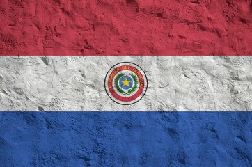 Paraguay flag depicted in bright paint colors on old relief plastering wall. Textured banner on...