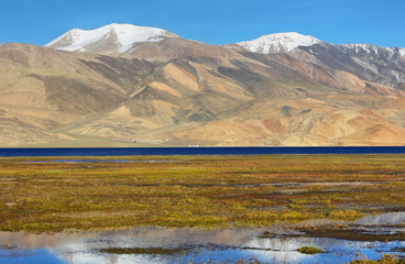 Reflection of Tso Moriri lake in Rupshu valley with Chamser and Lungser Kangri peaks at background in Ladakh, India