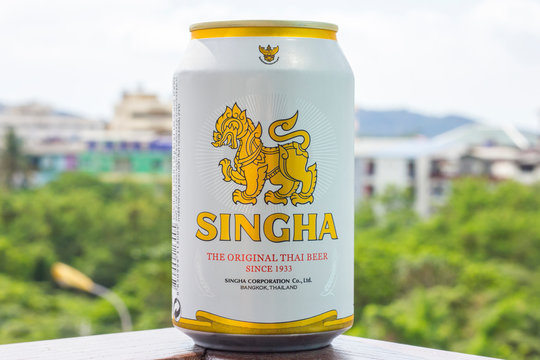 A new bottle of Singha beer Original on the background of nature