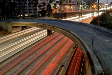The Harbor Freeway as seen at night with the sixth street ramp curving across the scene.