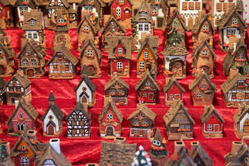 Fototapeta premium Women holding little house toy near pine branches.