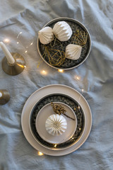 Christmas table setting with ceramic stoneware and origami decorations