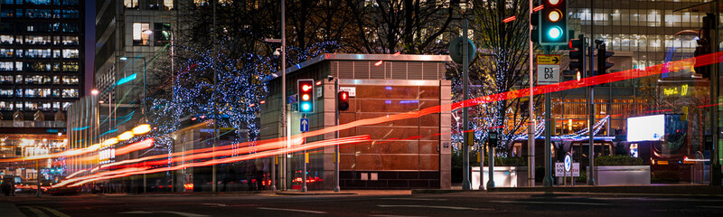 Busy city street at night with light streaks from vehicles panoramic