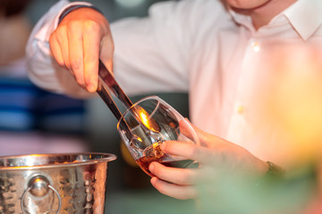 Selective focus shot of a barista making an alcoholic drink during a party