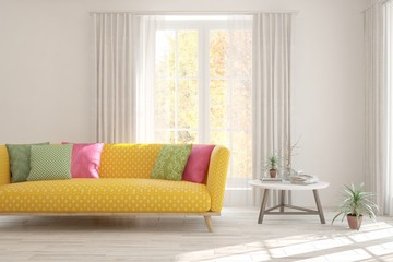 Stylish room in white color with sofa and autumn landscape in window. Scandinavian interior design. 3D illustration