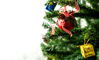 A Red Christmas ornament and gift boxes on a Christmas Tree