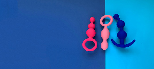 Banner. Three butt plugs on bright background. Useful for sex shop