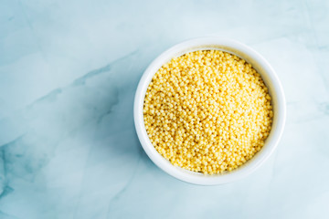 Dried millet porridge in the white bowl