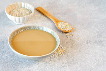 Ceramic bowl with tahini . Close up with copy space