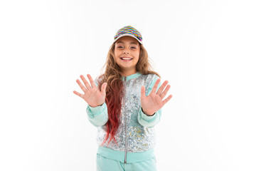 Little pretty caucasian girl in a tracksuit wave hands, picture isolated on white background