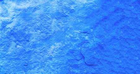 Blue background of natural cement or old stone.Vintage texture of decorative plaster or grungy marble. Trendy color 2020. Close-up