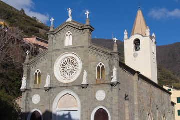 The front view of upper facade of San Giovanni Battista Church in Riomaggiore, Cinque Terre,...