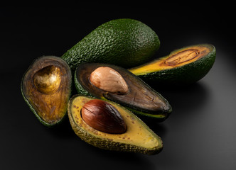 cut, dried avacadone against black background