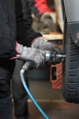 Mechanic checking the pressure of a van tire
