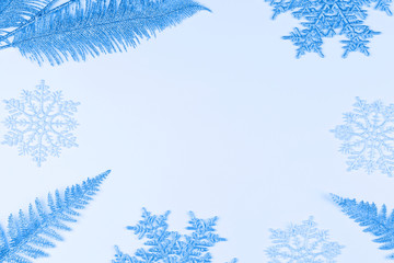 Christmas or winter composition. snowflakes and tree branches on color background.