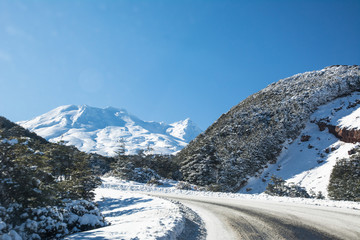 Fototapeta na wymiar Icy road in mountains on a bright sunny day