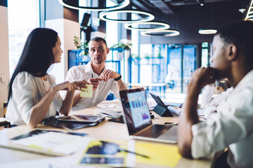 Thoughtful multiracial colleagues sharing ideas on meeting