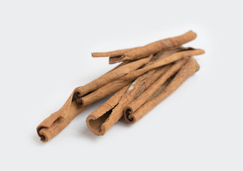 Several cinnamon sticks isolated on grey background.