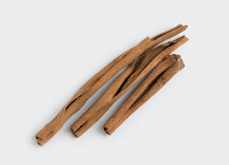 Several cinnamon sticks isolated on grey background.