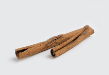 Several cinnamon sticks isolated on grey background.