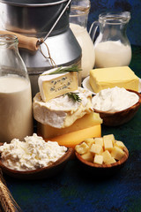 Different  healthy dairy products on rustic background with milk, cheese, butter and cottage