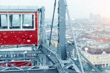 aerial panoramic citiscape view of Vienna from top of Prater amusement fair park ferris wheel during snowfall on cold snowy day. Winter Vienna holiday travel background