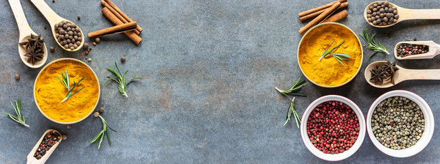 Fototapeta na wymiar Long wide banner with different organic aromatic spices on rustic stone background with copy space for your design. Template culinary blog social media.