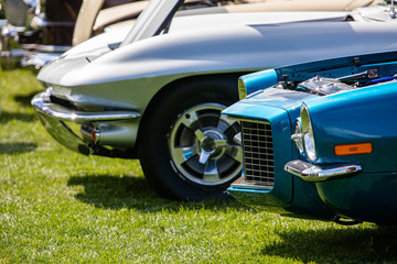 Old Classic American white and blue fast cars front, side view on the grass during an outdoor sunny...