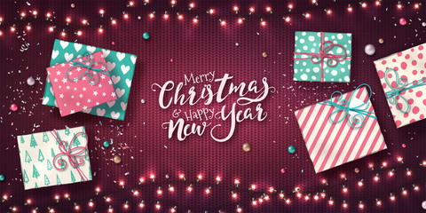 Christmas and new year banner with gift boxes, xmas garlands of lights, baubles and glitter confetti on purple knitted texture. Horizontal holiday background with glowing LED light bulbs. Vector