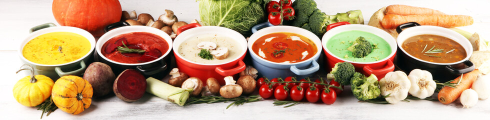 Variety of colorful vegetables cream soups and ingredients for soup. Concept of healthy eating or...