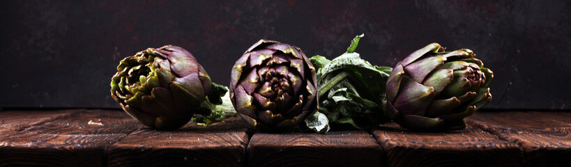 artichokes on rustic background. fresh raw organic artichoke flower.