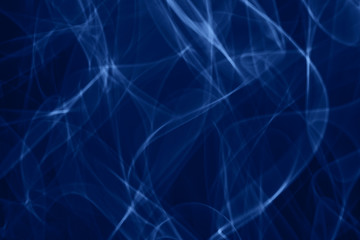 Blue neon smoke abstract. Neon lines. Color of the year concept.  Abstract black background. Neon lights texture.