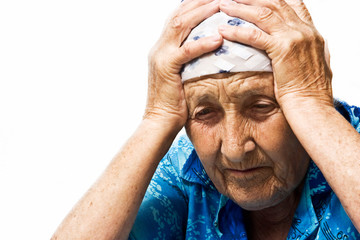 Old grandmother endure a headache close up