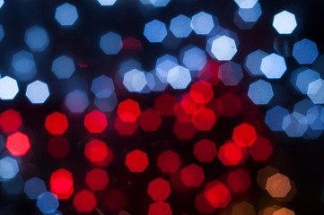 Christmas holiday festive glittering defocused redand blue background with bokeh lights