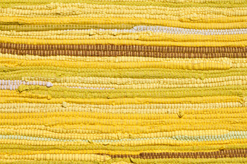 detail of yellow rug with horizontal lines