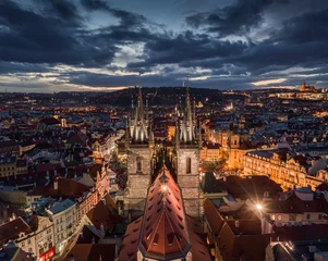 Rolgordijnen Prague, Czech Republic - Aerial drone view of the famous illuminated Church of our Lady Before Tyn with the Christmas market, Old Town Hall & Old Town Square at background by night © zgphotography