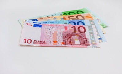 Four different euro banknotes on white background
