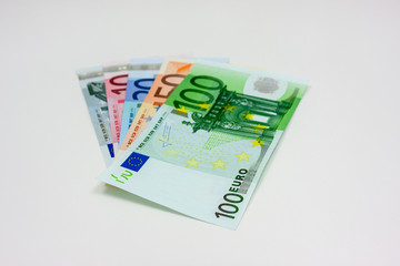 Five different euro banknotes on white background