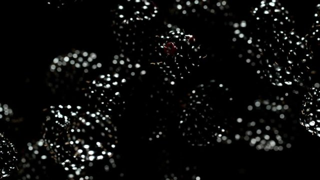 Exploding blackberries on a black background. Filmed on high speed cinema camera, 1000fps.