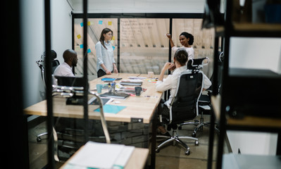 Fototapeta premium African American office employee creating project with partners