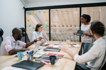 African american office employee creating project with coworker