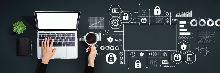 Cyber security theme with person using a laptop computer