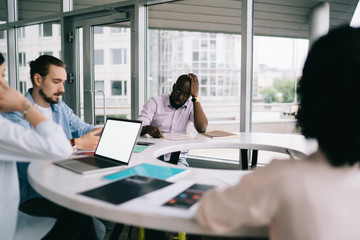 Group of business people working on project together at formal meeting