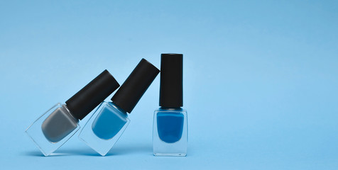 Nail polish on blue background. Color of the year 2020.