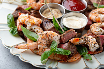 Christmas or New Year party appetizer, shrimp and steak with dipping sauces