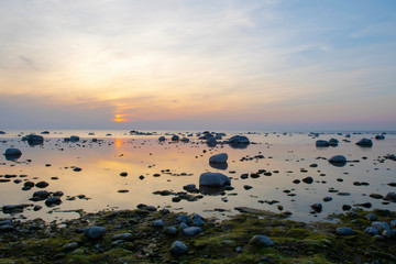 Rocky seashore in sunset time