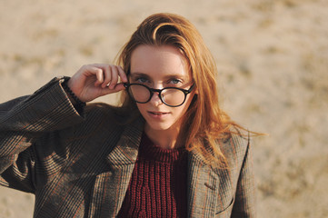 Young hipster girl posing outdoors, outdoor fashion portrait, sunglasses, street style, red lips...