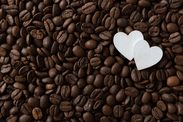 Coffee beans with white hearts, with smoke and copy space